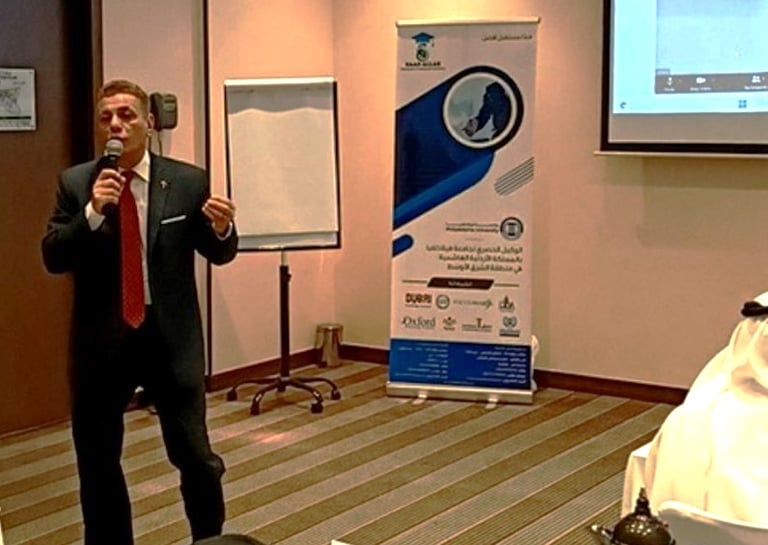 Major General Ayman Syedelahl wearing an elegant suit, providing a training course in AbuDhabi, UAE
