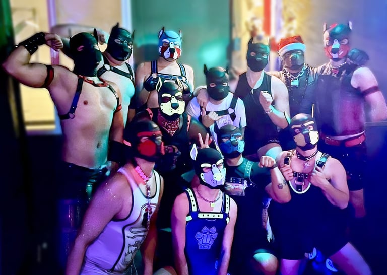 A group of men in pup masks posing together in a club
