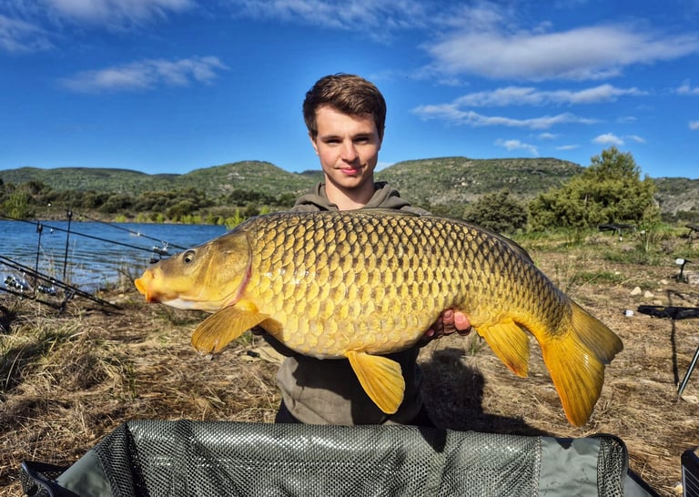 a man holding a fish carpel fish