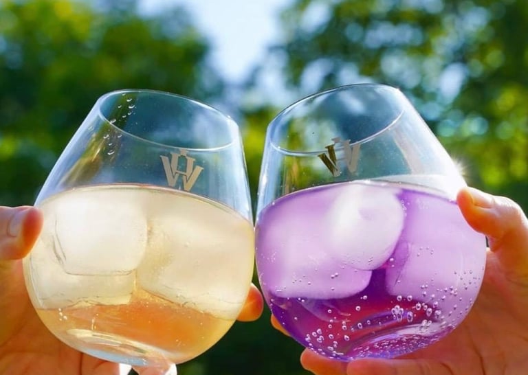 Photo of two glasses against eachother with Holy-Water Cuberdon Gin inside