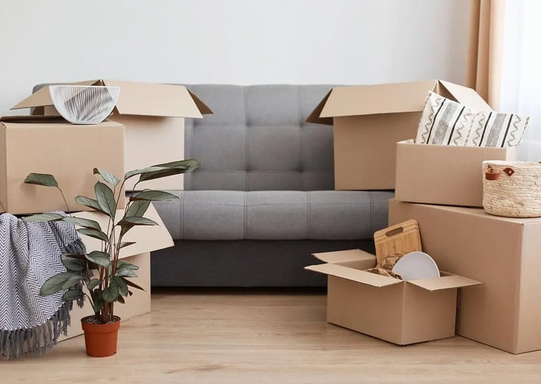 a couch and some boxes for moving in/out