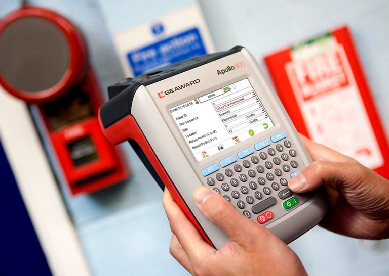 a person holding a portable appliance tester