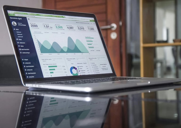 laptop with graphs on screen
