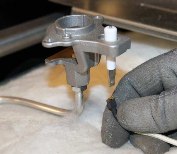 A technician holding an range igniter spark plug