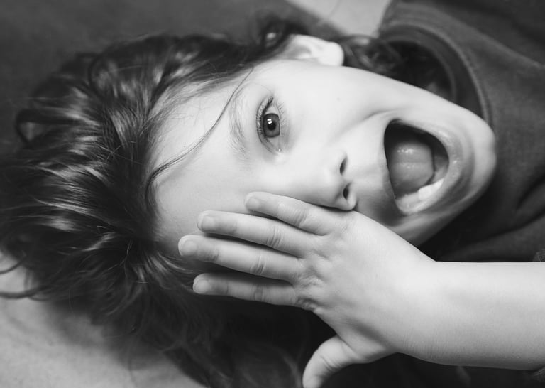 a young child with a toothbrush in her mouth