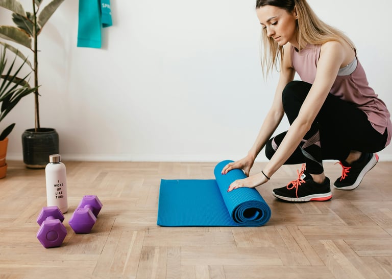 a woman is sitting on a yoga mat with a blue yoga mat