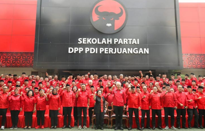 a group of people standing in front of a large sign