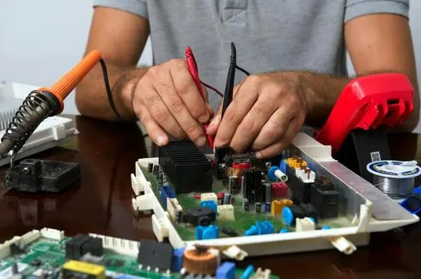 Technician assembling custom electronics and OEM circuit board components