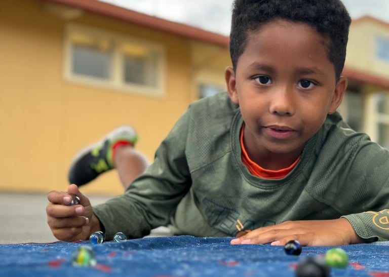 boy playing marbles