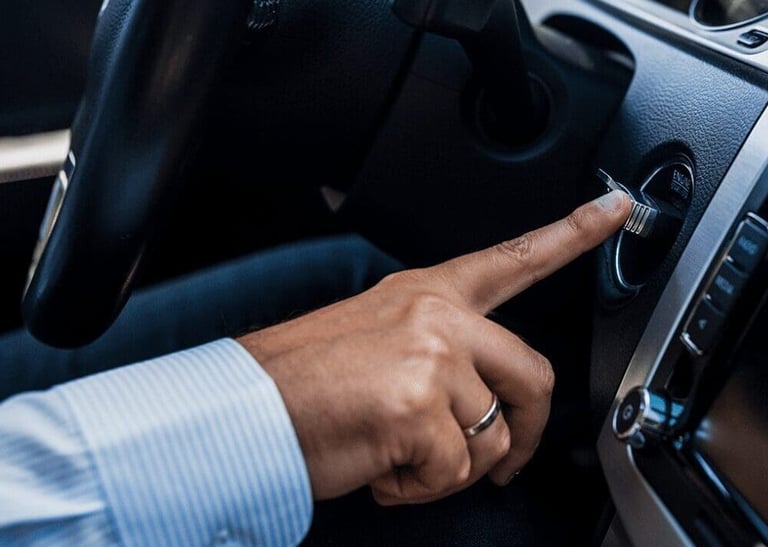a man's hand is pressing a button on a car