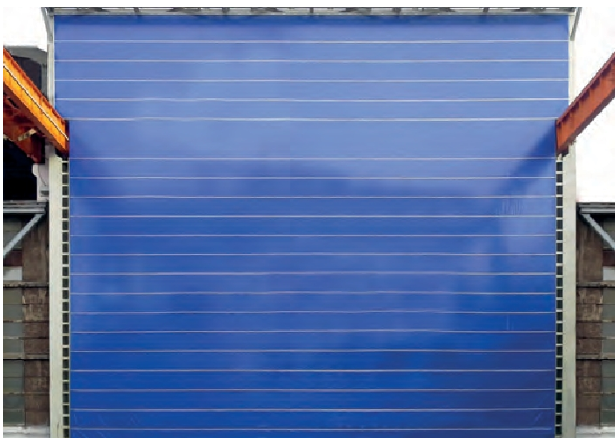 Large blue industrial high-speed fabric roll-up door for warehouse and hangar access.