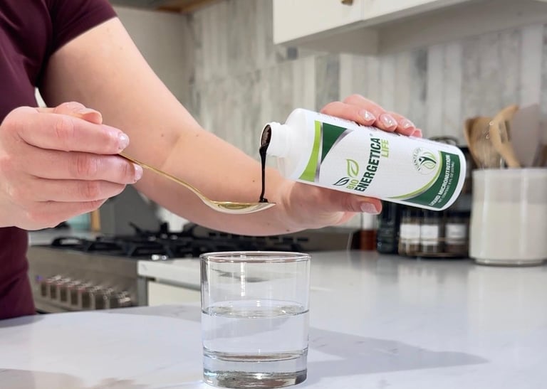 Bioenergetica Life liquid supplement being poured into a spoon, designed for easy daily absorption