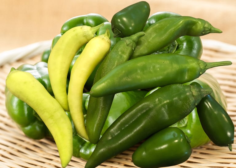a basket of peppers on a wicker basket