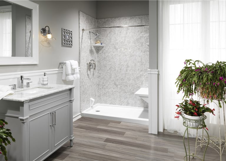 Walk-in shower with gray marble walls and vanity installed by Toledo New Bath.