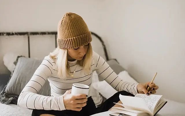 teen girl reading and making notes