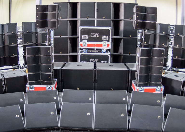 a large group of l'Acoustics speakers and speakers in ESME storage