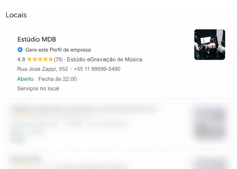 a person holding a cell phone in front of a photo of a man in a