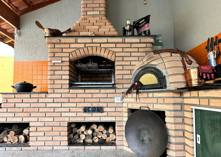 a brick oven with a pizza oven and a pizza oven
