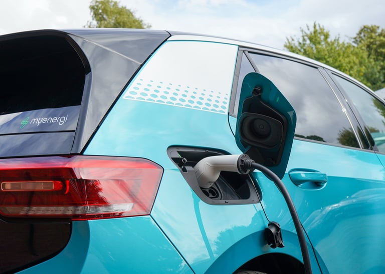 electric vehicle charging at a station using a plugged-in EV cable.