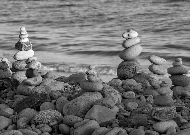 zen rocks stacked on top of one another with ocean in the background in montauk point