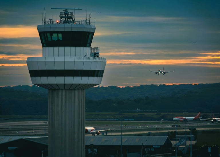 Air traffic control tower with an airplane ready to land on the runway at Gatwick Airport