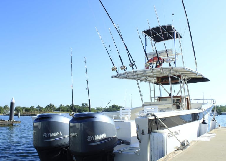 a boat docked at a dock with fishing rods