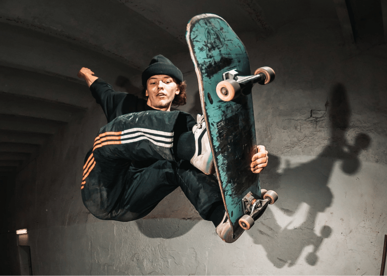 a man in a black jacket and a skateboarder in the air