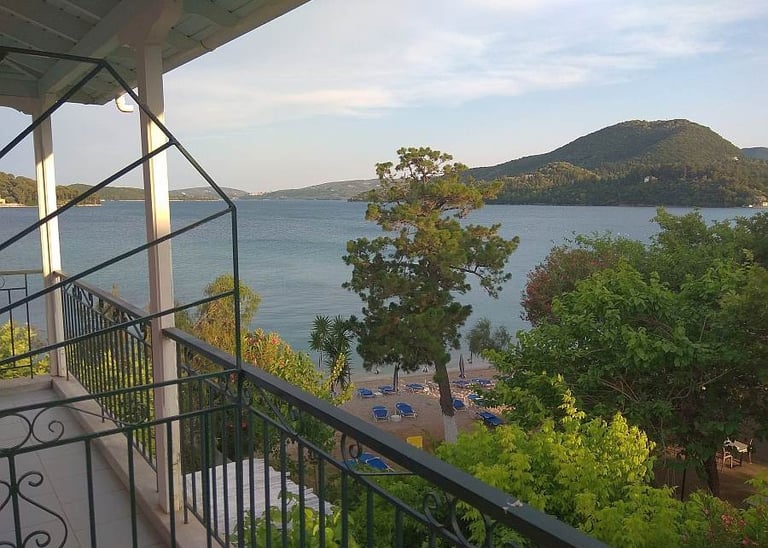 a balcony with a view of the sea and mountains