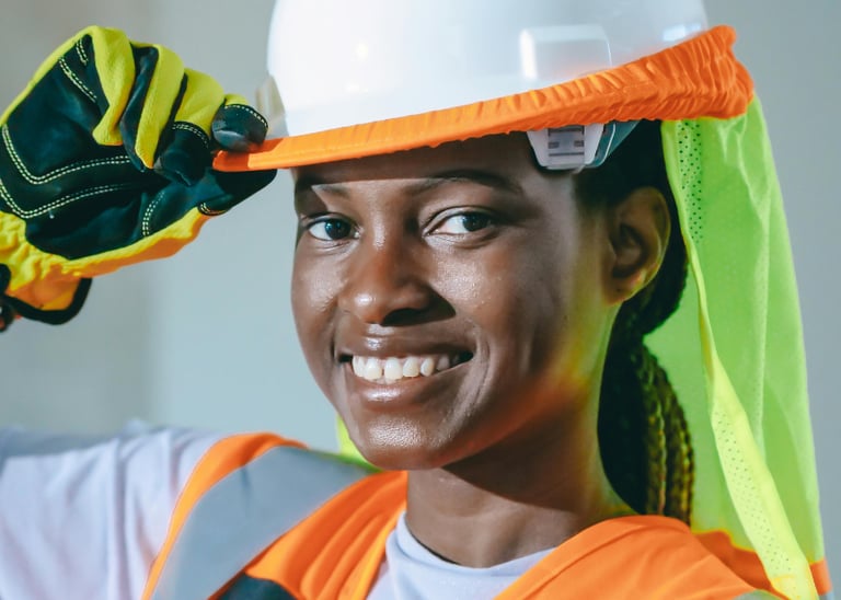 A service business tech smiling while working on a jobsite Photo by Kindel Media