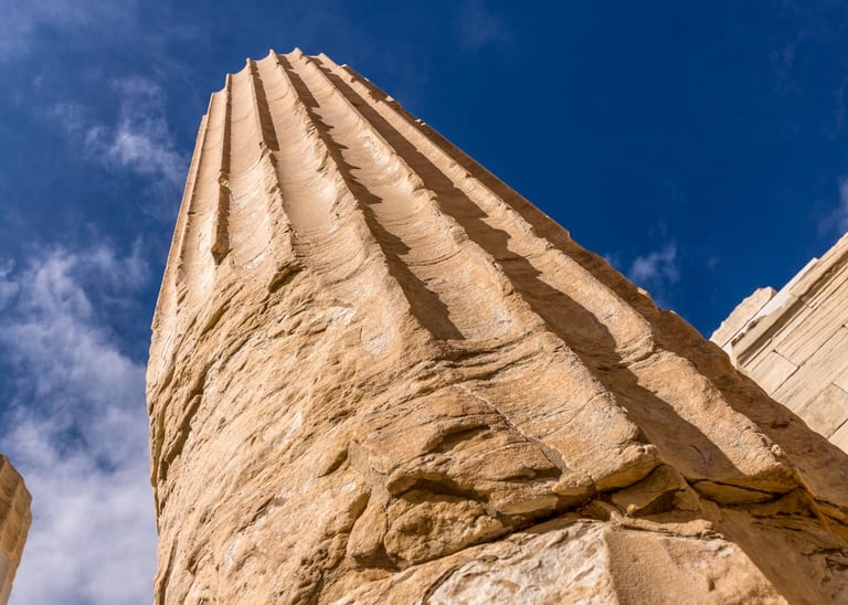 a tall stone column with a blue sky in the background