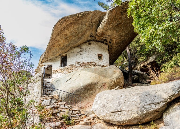 a stone building with a stone wall and stairs