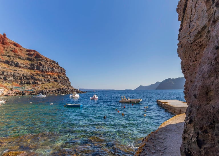 a boat in the water near a cliff