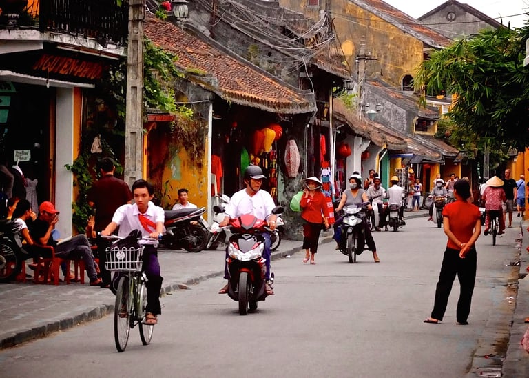 a group of people riding bikes down a street