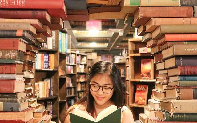girl reading in a circle of books