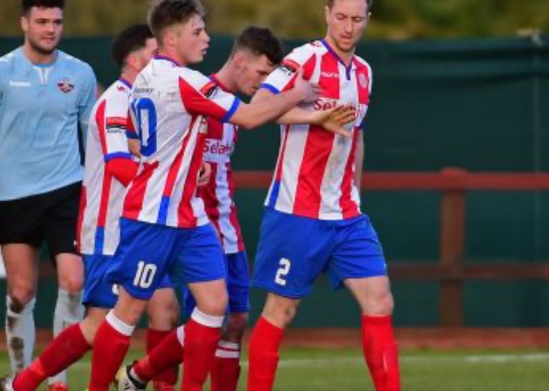 Robb Sheridan, semi professional footballer, celebrating with teammates during a match.