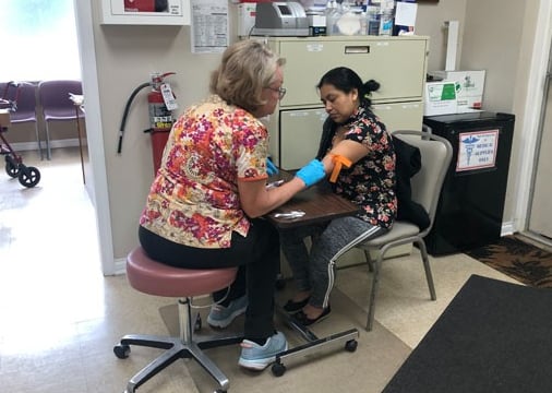 A patient having blood work done at the Center for Hope and Healing medical clinic