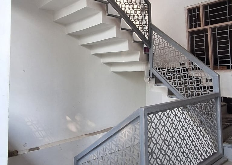 a staircase with a metal railing and a metal railing