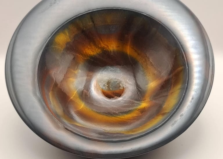 Handmade heavy bowl with a metallic charcoal rim and a glossy amber and gold marbled glossy finish