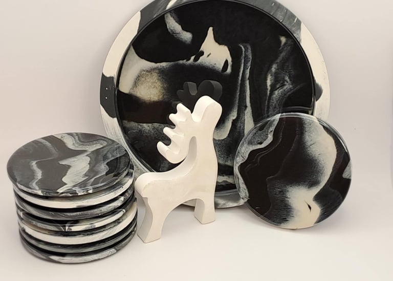Handmade marbled coasters, a large tray, and a white reindeer figurine made from pigmented gypsum