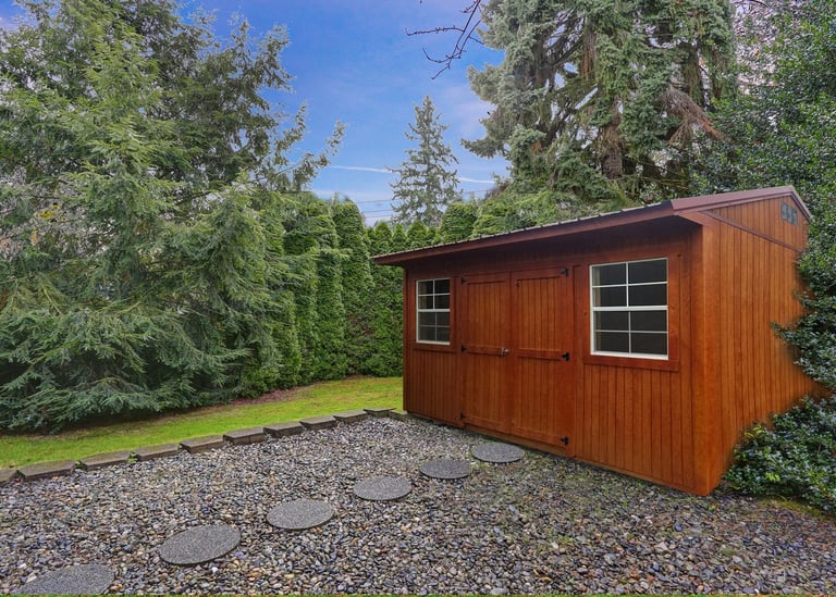 Colonial style shed with lawn and trees