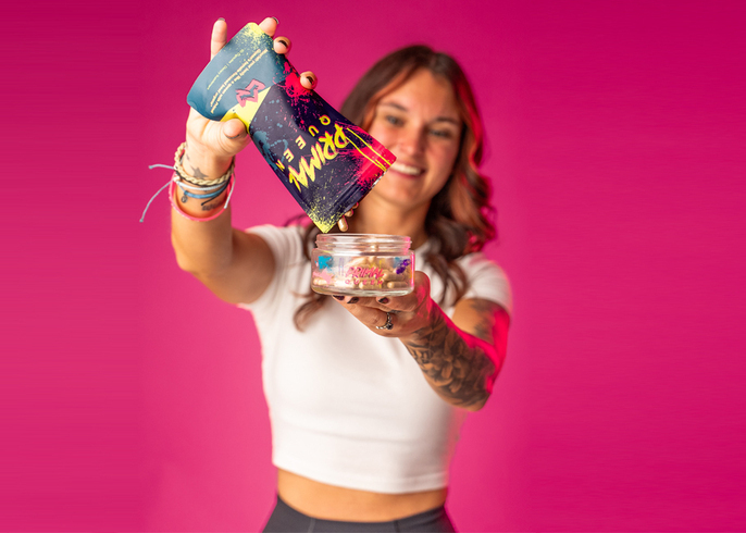 primal queen founder holding a supplement product