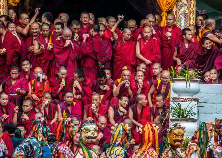 Masked-dancer-with-Monks-in-The-Backdrop-in-Thimphu
