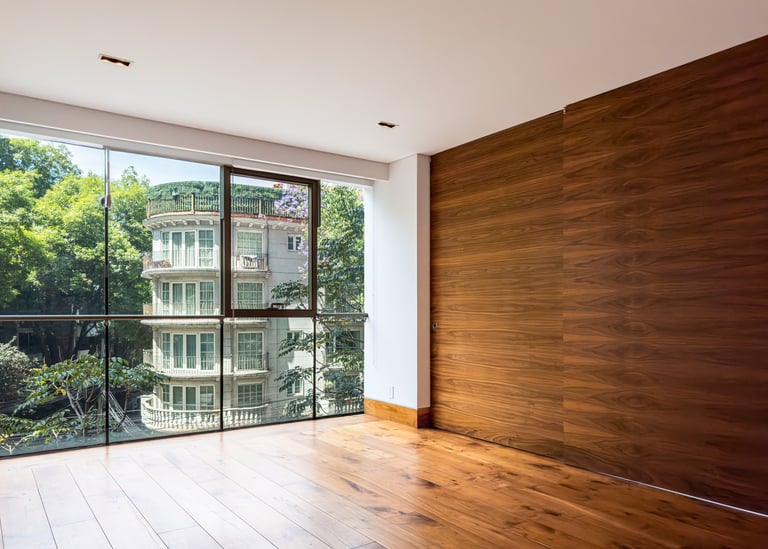 a room with a large window and a wooden floor