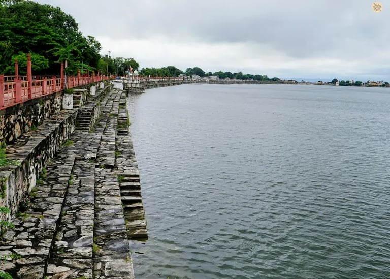 Rajsamand Lake shimmering in soft morning light with calm reflections and peaceful surroundings.