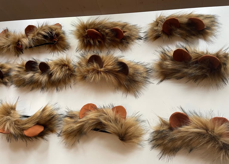 Handmade brown faux fur lion headbands with rounded ears for animal costumes.