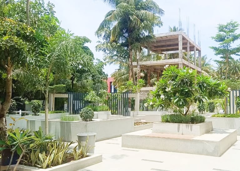 Employee-friendly corporate exterior with walking paths and greenery by Garden Designers