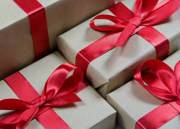 a bunch of gift boxes with red ribbons