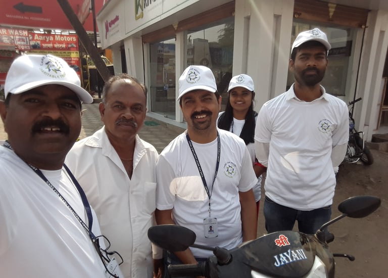 a group of men and a woman standing around a motorcycle