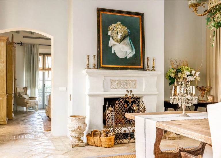 Fireplace with artwork and rustic decor at Finca Santa Katerina
