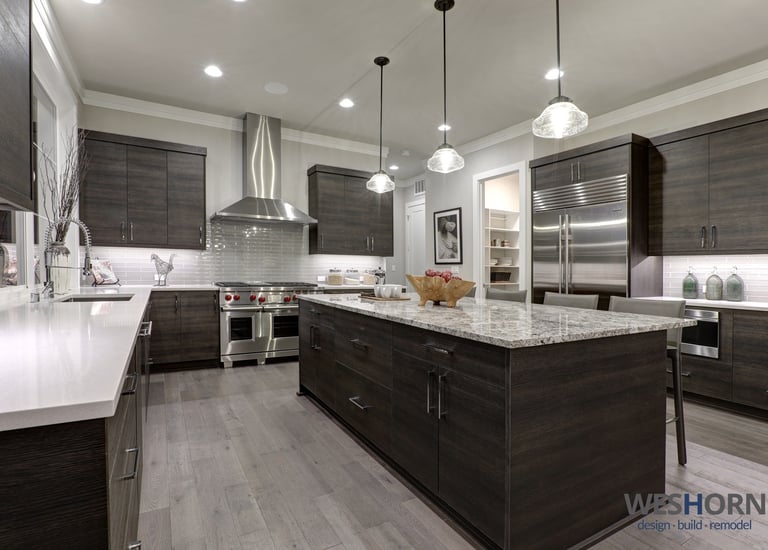 Sleek kitchen featuring dark wood cabinets and stainless steel appliances.
